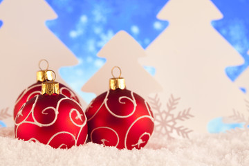 Decorative Christmas baubles on snow