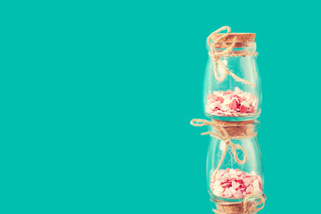 Love concept with jars on a turquoise background, horizontal, pa