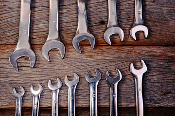 wrenches on wood background