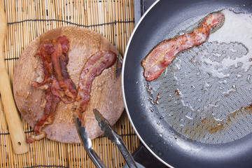 Chef putting crispy bacon to the plate