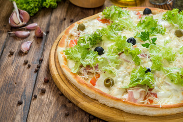 delicious italia pizza in a restaurant, on the wooden desk