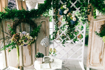 Little flowerpot with greenery, lamp and champagne flutes stand