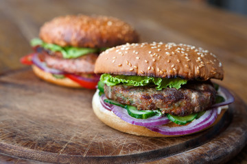 Classic american burgers, fast food on wood background