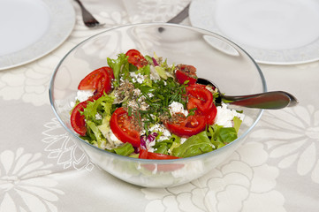 Fresh salad in the glass bowl