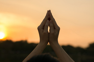 Silhouette people pray from Buddha statue to hope for help on sun set and bokeh background....