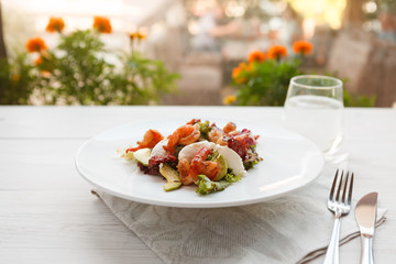 Traditional italian seafood salad with shrimps and mozzarella