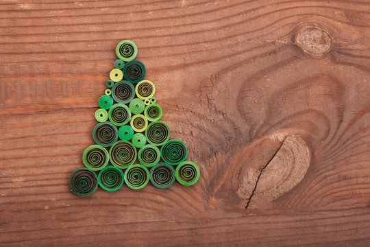 Firtrees made with quilling technique on a wooden surface