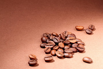 Coffee beans close-up on a brown background