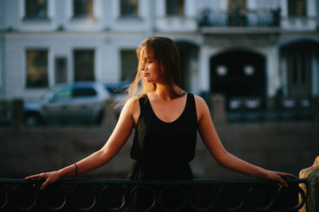 young and graceful woman standing outdoors alone