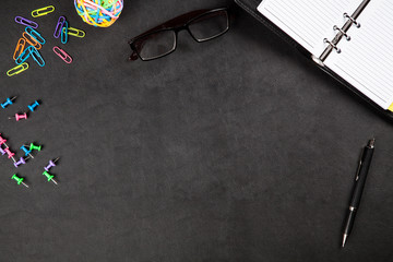 Office supplies on a black table