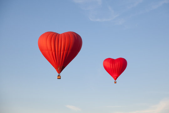 Heart shaped balloon. A journey for lovers. Aerostat against the blue sky.