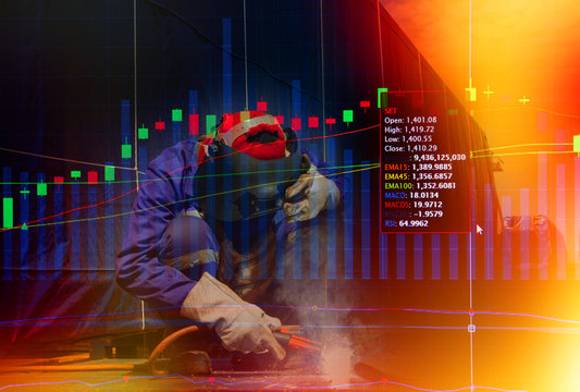 Stock market concept with Industrial Worker at the factory welding.