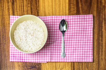 organic rice in bowl on wooden table before dinner cook