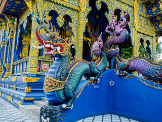 Fototapeta premium Chiang Rai, Thailand : November 27, 2016 , The fierce face naga sculpture at Rong Suea Ten Temple, the temple which is decorate in blue tone color, Chiang Rai, Thailand