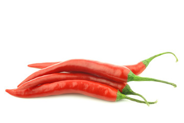 bunch of red hot chili peppers on a white background