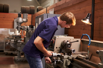 Male Engineer In Factory Using Milling Machine