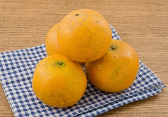 Stack of Ripe Oranges on A Wooden Table
