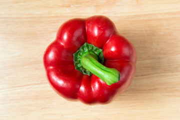 red sweet pepper on a wooden block