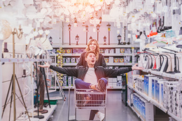 young couple shopping for DIY tools at hardware store.cheerful young couple shopping in hardware store - obrazy, fototapety, plakaty