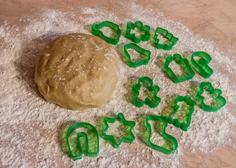 Ball of dough  with dusting of flour and cookie cutter forms