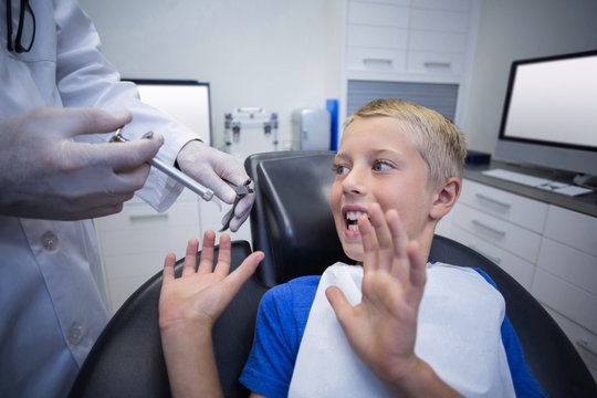 Young patient scared during a dental check-up - Powered by Adobe