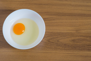 eggs in white cups .on wood background,top view,space for text.