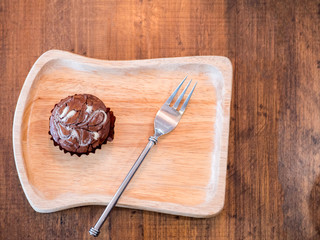Homemade artisan dark chocolate brownies , on wood dish