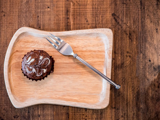 Homemade artisan dark chocolate brownies , on wood dish