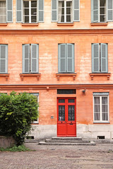 Fototapeta na wymiar french house with red door