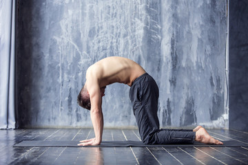 Yoga men workout on black mat.