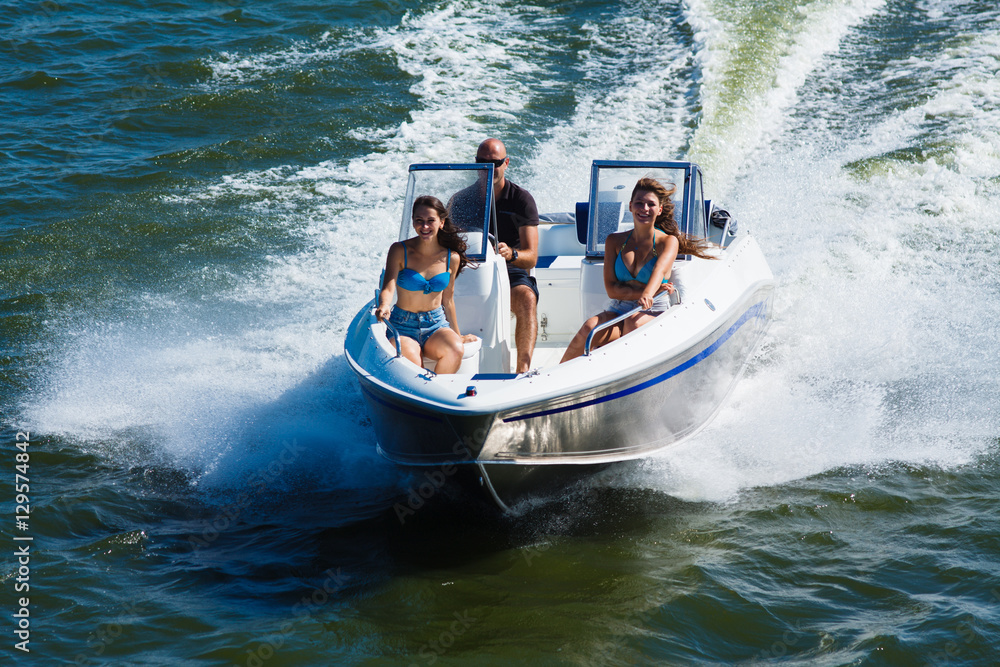 Wall mural  Girls ride on the boat to drift