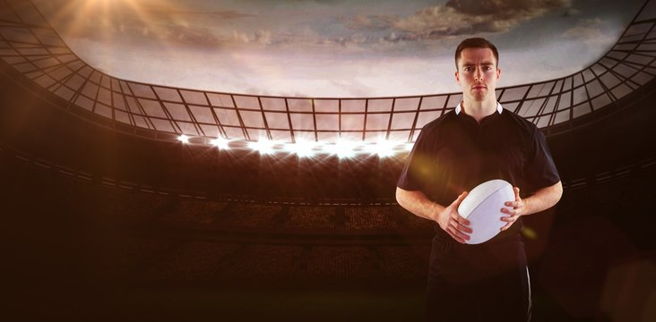 Composite image of rugby player holding a rugby ball 3D