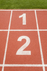 1 and 2 number on race track in football stadium.