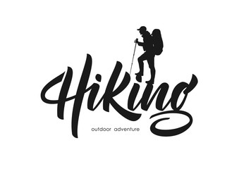 Vector illustration: Modern brush lettering of Hiking with silhouette of climber.