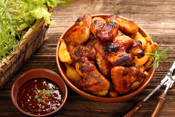 Chicken wings with baked potatoes and barbecue sauce