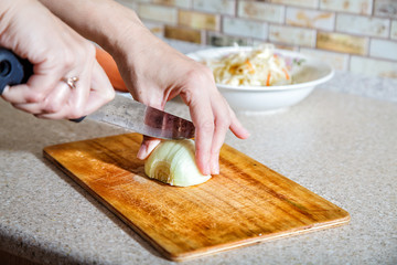 woman cuts onion