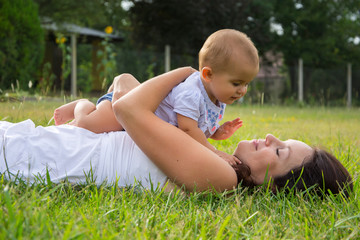 Portrait of happy loving mother and her baby outdoors