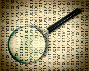 magnifying glass on a binary code