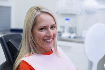 Patient checking her teeth in mirror