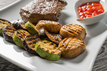 Appetizing stake on white plate. Grilled meat