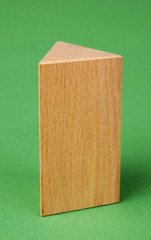wooden geometric shapes on a green background