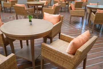 Many table with four chairs on wooden floor