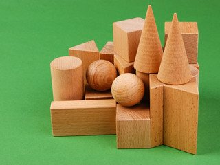 wooden geometric shapes on a green background