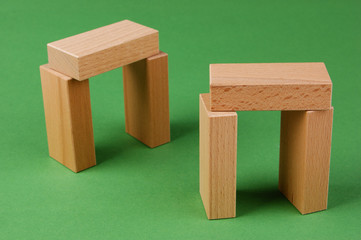 wooden geometric shapes on a green background