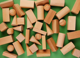 wooden geometric shapes on a green background