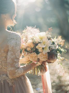 Bride standing holding bouquet