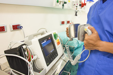 doctor use EKG or ECG and test defibrillator system in emergency - obrazy, fototapety, plakaty