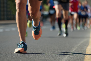 Marathon running race, people feet on city road