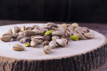 Pistachio nuts on the wood table and wood background