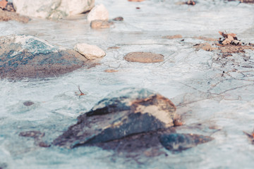 Detail of frozen stream cracked in winter
